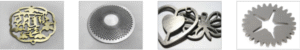 A horizontal row of four images showing intricate metal parts produced by a laser cutting machine, illustrating its use cases: 1) A decorative, ornate brass medallion with cutout text. 2) A round, silver disc with a precise, spiraling pattern of small holes. 3) A close-up of small, brushed metal jewelry-like cutouts, including a heart and a bow. 4) A mechanical-looking, silver gear with multiple internal star-shaped cutouts